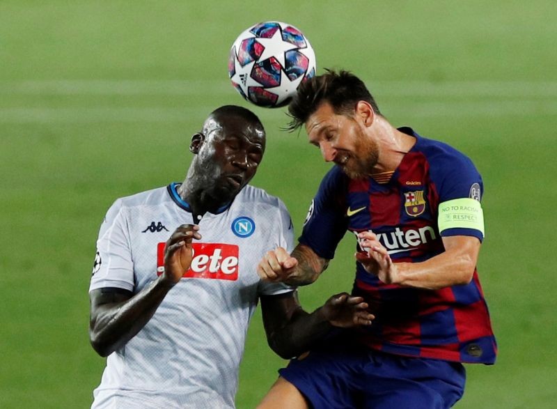 Barcelona's Lionel Messi in action with Napoli's Kalidou Koulibaly, as play resumes behind closed doors following the outbreak of the coronavirus disease (COVID-19) REUTERS/Albert Gea