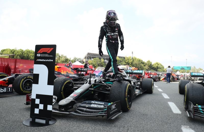 Mercedes' Lewis Hamilton gets out of the car after winning the race Pool via REUTERS/Albert Gea