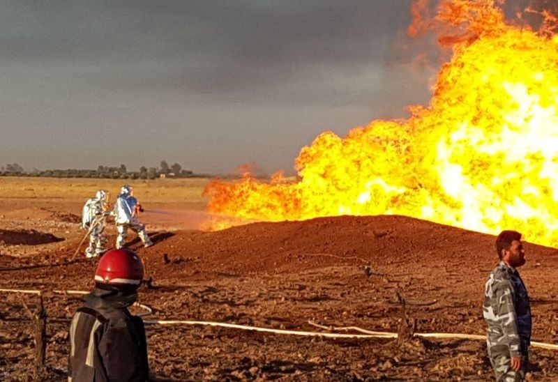 Firefighters spray water on the fire that resulted from an explosion on the Arab Gas Pipeline between the towns of Ad Dumayr and Adra, northwest of the capital of Damascus, Syria, in this handout released by SANA on August 24, 2020. (REUTERS Photo)