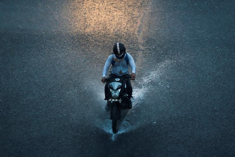 A man rides a motorbike during heavy rains in New Delhi, India. REUTERS/Adnan Abidi  