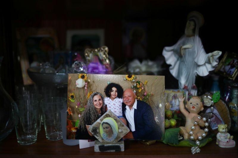 A photograph shows a missing silo employee Ghassan Hasrouty posing with his family, in the family home following Tuesday's blast in Beirut's port area, Lebanon on August 9, 2020. (REUTERS Photo)