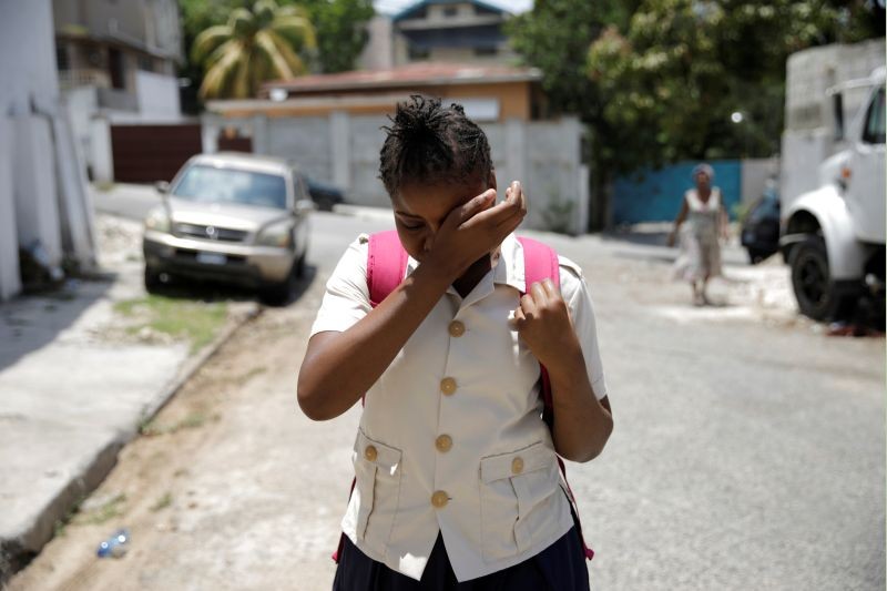 Nickerla Ambroise Etienne dries her tears, after being informed that she cannot attend school yet, as she walks along a street in Port-au-Prince, Haiti on August 17, 2020. (REUTERS Photo)