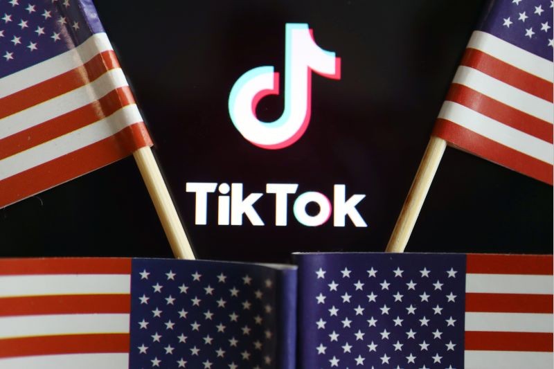 U.S. flags are seen near a TikTok logo in this illustration picture taken on July 16, 2020. (REUTERS File Photo)