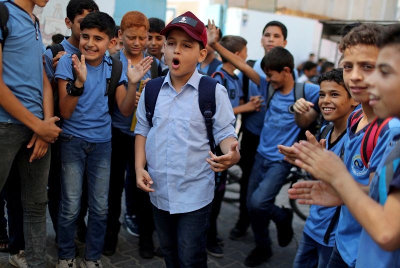 Abdel-Rahman Al-Shantti, an 11-year-old Gaza rapper, is surrounded by students as he performs in his school in Gaza City on August 16, 2020. (REUTERS Photo)