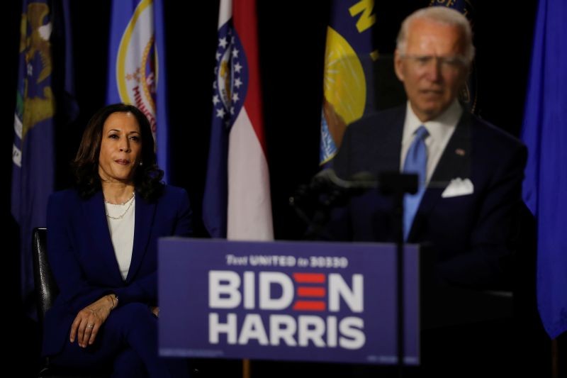 Democratic vice presidential candidate Senator Kamala Harris listens as Democratic presidential candidate and former Vice President Joe Biden speaks at a campaign event, their first joint appearance since Biden named Harris as his running mate, at Alexis Dupont High School in Wilmington, Delaware, US on August 12, 2020. (REUTERS Photo)