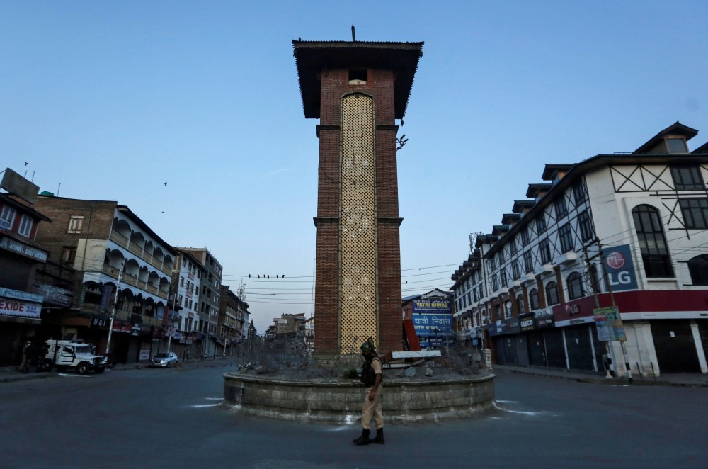 An Indian Central Reserve Police Force (CRPF) officer stands guard at an empty square during a lockdown on the first anniversary of the revocation of Kashmir's autonomy, in Srinagar on  August 5.  (REUTERS/Danish Ismail)