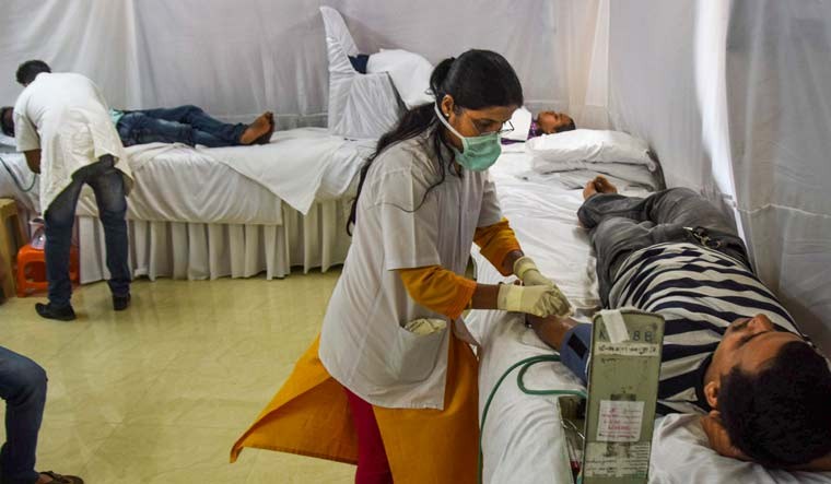 Volunteers donate blood at at a camp organised at Lalbagcha Raja Society premises to support coronavirus patients, in Mumbai | PTI