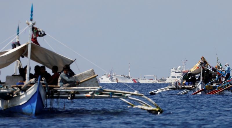 China Coast Guard vessels patrol past Philippine fishing boats at the disputed Scarborough Shoal on April 5, 2017. (REUTERS File Photo)