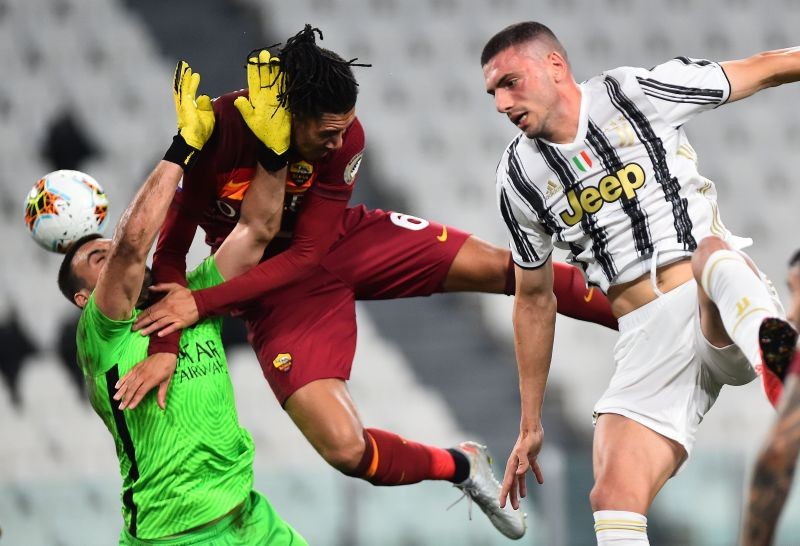 AS Roma's Chris Smalling and Daniel Fuzato in action with Juventus' Merih Demiral, as play resumes behind closed doors following the outbreak of the coronavirus disease (COVID-19) REUTERS/Massimo Pinca