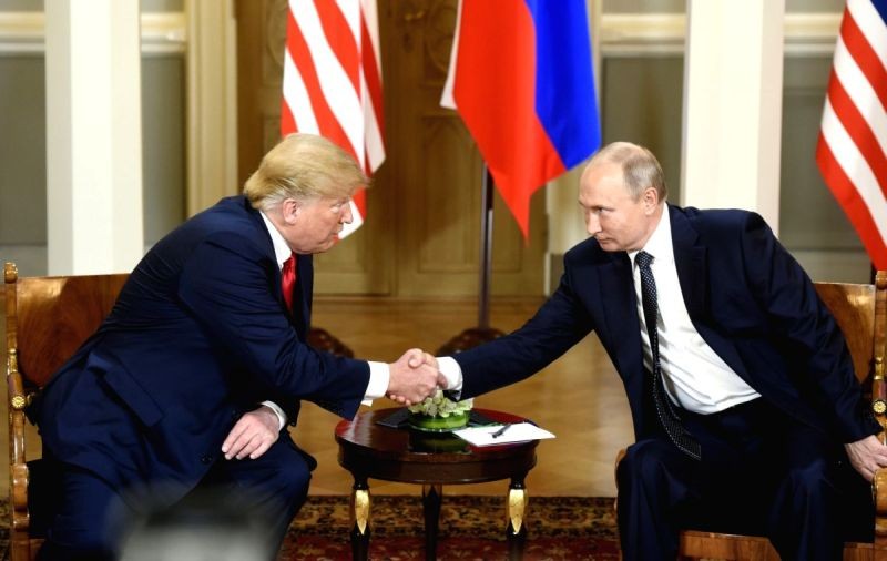 U.S. President Donald Trump (L) shakes hands with his Russian counterpart Vladimir Putin in Helsinki, Finland, on July 16, 2018. (IANS File Photo)