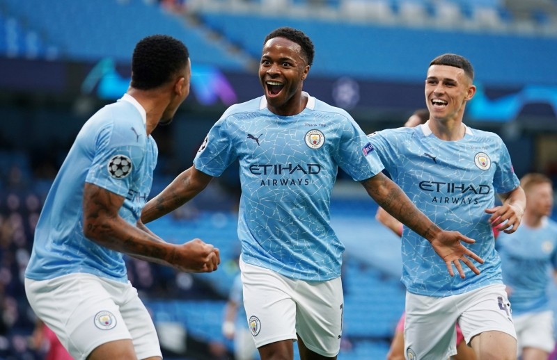 Manchester City's Raheem Sterling celebrates scoring their first goal with teammates, as play resumes behind closed doors following the outbreak of the coronavirus disease (COVID-19) Pool via REUTERS/Dave Thompson