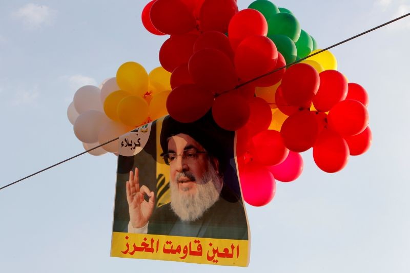 Balloons with a picture of Lebanon's Hezbollah leader Sayyed Hassan Nasrallah hang in the air during a rally marking the anniversary of the defeat of militants near the Lebanese-Syrian border, in al-Ain village, Lebanon on August 25, 2019. (REUTERS File Photo)