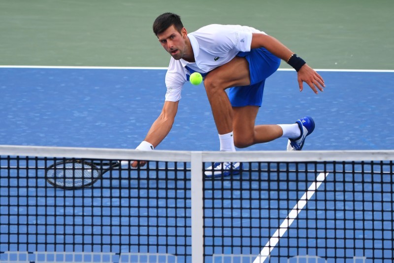 FILE PHOTO: Aug 25, 2020; Flushing Meadows, New York, USA; Novak Djokovic (SRB) hits the ball against Tennys Sandgren (USA) during the Western & Southern Open at the USTA Billie Jean King National Tennis Center. Mandatory Credit: Robert Deutsch-USA TODAY Sports