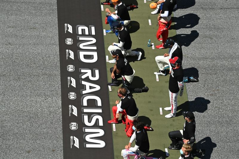 Drivers on the grid kneel down wearing an anti-racism T-shirt before the race Joe Klamar/Pool via REUTERS/File Photo