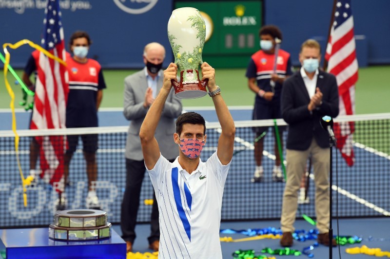 Mens champion Novak Djokovic (SRB) hoists the trophy as he celebrates his win over Milos Raonic (CAN) in the Western & Southern Open at the USTA Billie Jean King National Tennis Center. (Robert Deutsch-USA TODAY Sports)