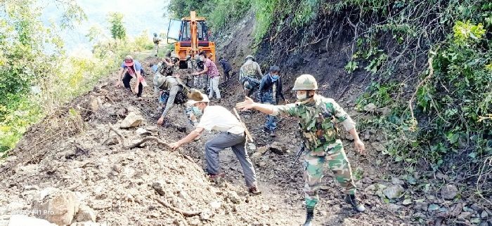 Assam Rifles personnel assisting villagers in clearing up the landslide along the Lopfukhong - Khongjiri border road on September 19.