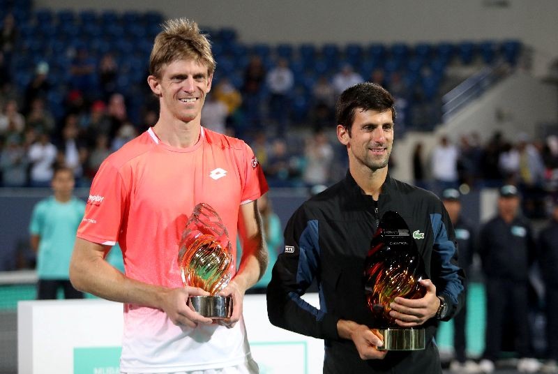 FILE PHOTO: Tennis - Mubadala World Tennis Championship - Abu Dhabi, United Arab Emirates - December 29, 2018 Serbia's Novak Djokovic and South Africa's Kevin Anderson pose with their trophies after Djokovic wins the final REUTERS/Suhaib Salem/File Photo