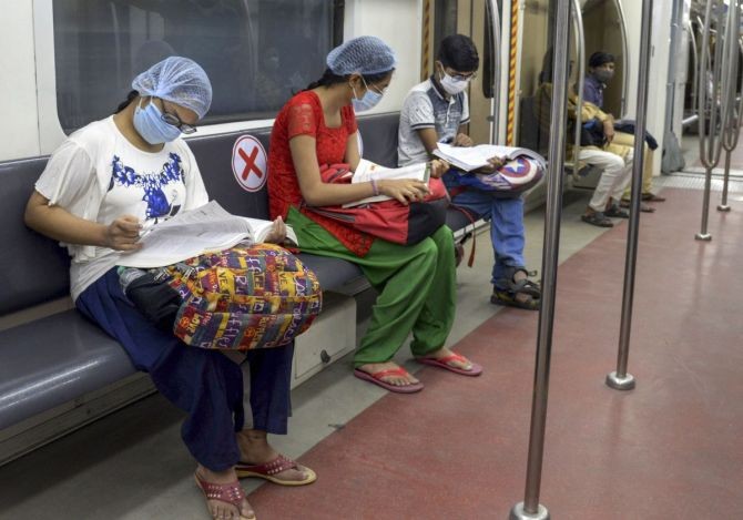 Candidates appearing in the National Eligibility-cum-Entrance Test travel in a metro train after the Kolkata Metro Rail Corporation resumed special service of 66 trains for NEET aspirants. Photograph: PTI Photo