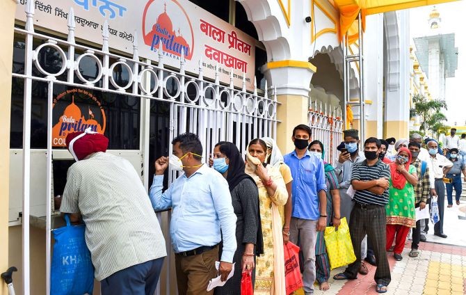 People wait in a queue at a pharmacy set up inside the Bangla Sahib Gurdwara to provide medicines to the needy at cheap rates, in New Delhi, on Monday. Photograph: Atul Yadav/PTI Photo