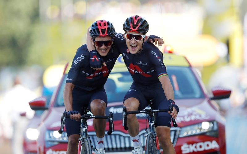 Team INEOS Grenadiers riders Michal Kwiatkowski of Poland and Richard Carapaz of Ecuador celebrate as they cross the finish line on September 17. REUTERS/Stephane Mahe/Pool
