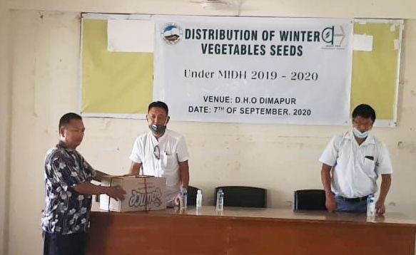 DHO Dimapur, Temsu handing over winter vegetable seeds to a farmer at DHO office premises Green Park Dimapur on September 7. (DIPR Photo)