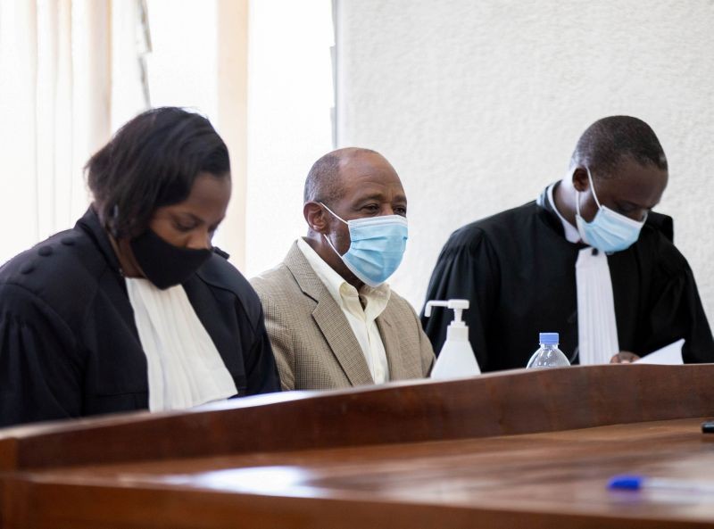 Paul Rusesabagina, portrayed as a hero in a Hollywood movie about Rwanda's 1994 genocide, sits with his lawyers Emmeline Nyembo and Rugaza David inside the Kicyikuri primarily court in Kigali, Rwanda on September 14, 2020. (REUTERS File Photo)