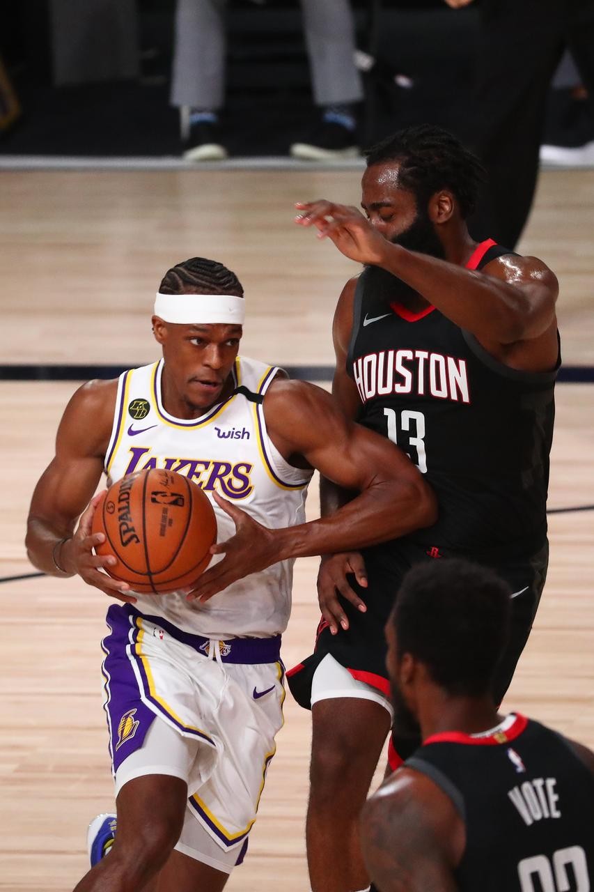 Lake Buena Vista, Florida, USA; Los Angeles Lakers guard Rajon Rondo (left) drives against Houston Rockets guard James Harden (13) during the first half of game three in the second round of the 2020 NBA Playoffs at AdventHealth Arena. Mandatory Credit: Kim Klement-USA TODAY Sports