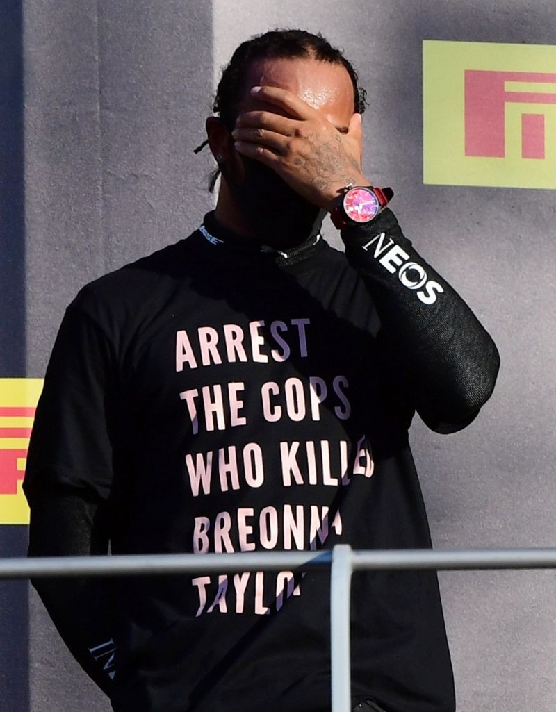 FILE PHOTO: Mercedes' Lewis Hamilton wears a shirt in reference to Breonna Taylor on the podium as he celebrates after winning the race Pool via REUTERS/Jennifer Lorenzini/File Photo
