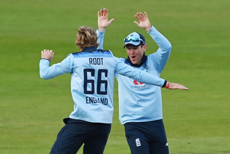England's Joe Root celebrates with Eoin Morgan after taking the wicket of Australia's Mitchell Marsh Pool via REUTERS/Shaun Botterill