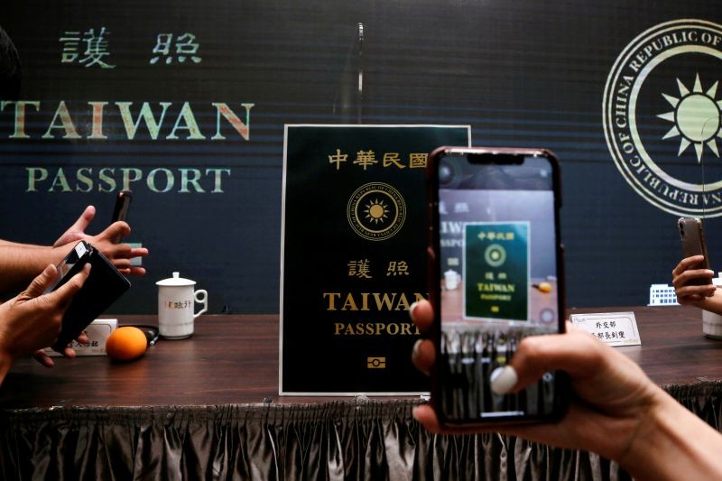 Members of the media take photos of a paper cut out of the new Taiwan passport displayed in Taipei, Taiwan on September 2. (REUTERS Photo)