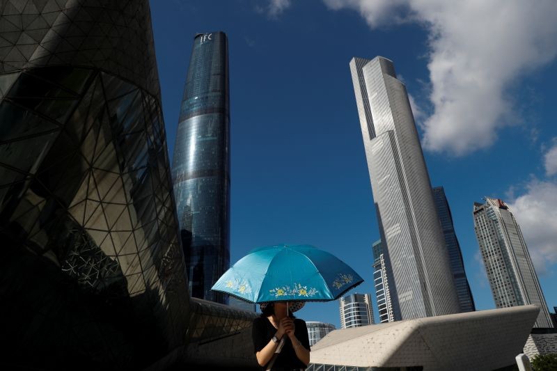 A woman stands with an umbrella outside the Opera House in Guanghzou, China on September 5, 2019. (REUTERS File Photo)