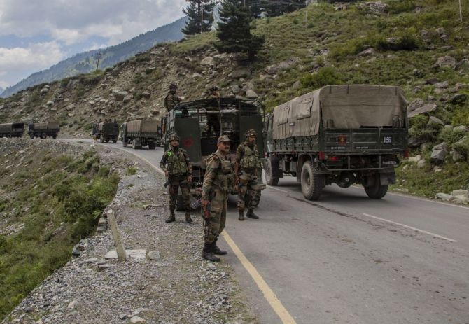 Indian Army convoy carrying reinforcements and supplies, drive towards Leh, on a highway bordering China. Photograph: Yawar Nazir/Getty Images