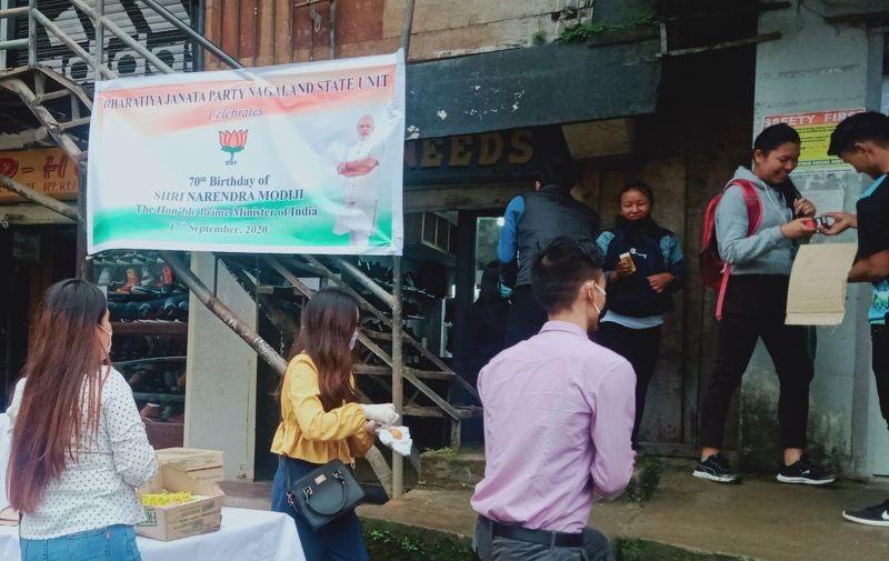 Nagaland’s state BJP distributes eatables to public on the street of Kohima to mark 70th birthday of Narendra Modi on September 17. (Morung Photo)