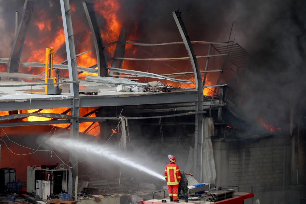 Men try to put out a fire that broke out at Beirut's port area, Lebanon September 10, 2020. REUTERS/Mohamed Azakir