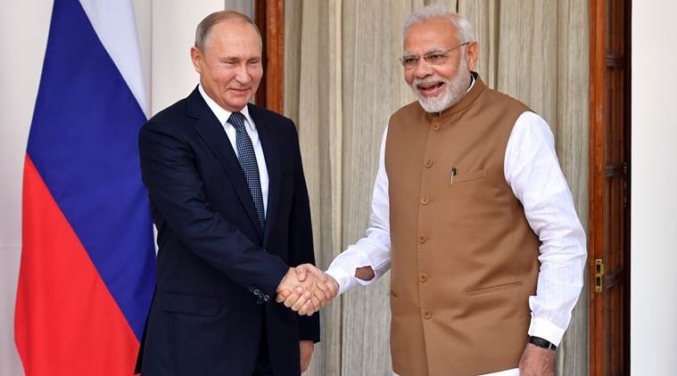 Indian Prime Minister Narendra Modi welcomes Russian President Vladimir Putin prior to their meeting at Hyderabad House in New Delhi, India October 5, 2018. Yuri Kadobnov/Pool via REUTERS