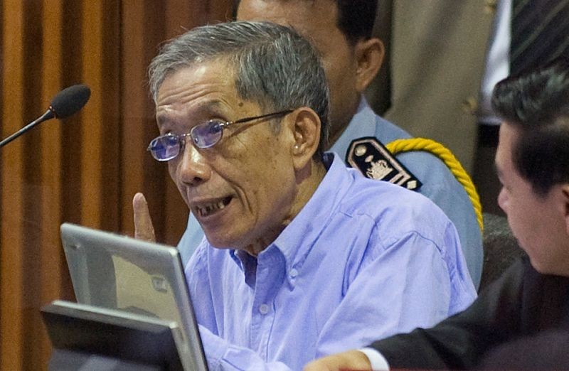 Khmer Rouge commander Kaing Guek Eav, also known as Duch, speaks to his attorneys moments before the start of his trial on the outskirts of Phnom Penh on February 17, 2009. (REUTERS File Photo)