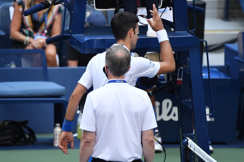 Novak Djokovic of Serbia discusses with a tournament official after being defaulted for striking a lines person with a ball against Pablo Carreno Busta of Spain (not pictured) on day seven of the 2020 U.S. Open tennis tournament at USTA Billie Jean King National Tennis Center.(USA TODAY Sports Photo via Reuters)