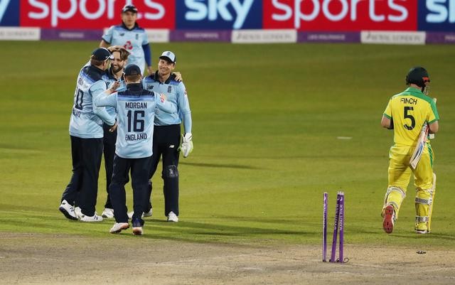 England's Chris Woakes celebrates the wicket of Australia's Aaron Finch with teammates during the Second One Day International  between England and Australia on September 13. (Reuters Photo)