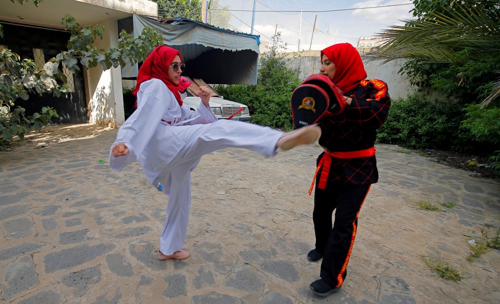 Martial arts trainer Seham Amer practices self-defense moves with a trainee at a house in Sanaa, Yemen September 5, 2020. Picture taken September 5, 2020. REUTERS/Nusaibah Almuaalemi