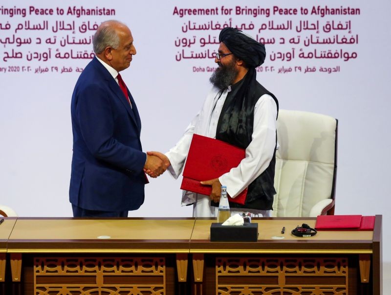 Mullah Abdul Ghani Baradar, the leader of the Taliban delegation, and Zalmay Khalilzad, U.S. envoy for peace in Afghanistan, shake hands after signing an agreement at a ceremony between members of Afghanistan's Taliban and the U.S. in Doha, Qatar on February 29, 2020. (REUTERS File Photo)