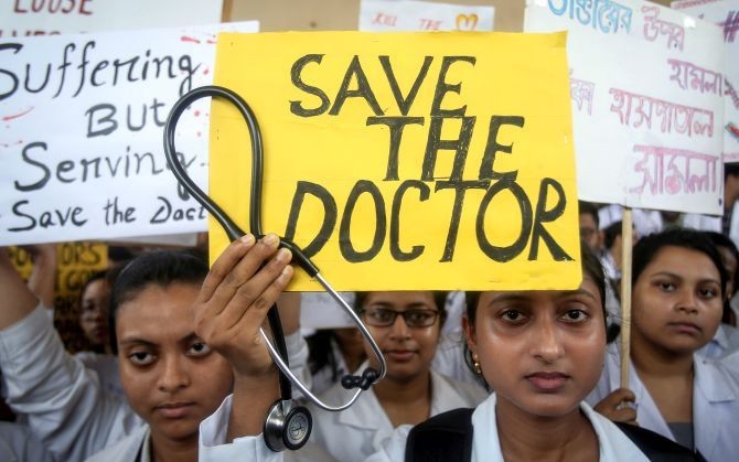 A doctor holds a placard at a government hospital in Kolkata during a strike demanding security after the recent assaults on doctors. Junior doctors called off their week-long strike on Monday, June 17, 2019. Photograph: Jayanta Dey/Reuters