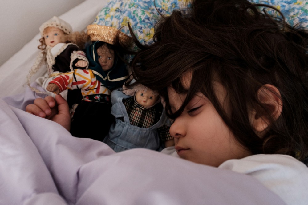 Two-year-old Bianca Toniolo sleeps surrounded by her toy dolls at home in San Fiorano in this picture taken by her father schoolteacher Marzio Toniolo, April 8, 2020. Picture taken April 8, 2020. Marzio Toniolo/via REUTERS