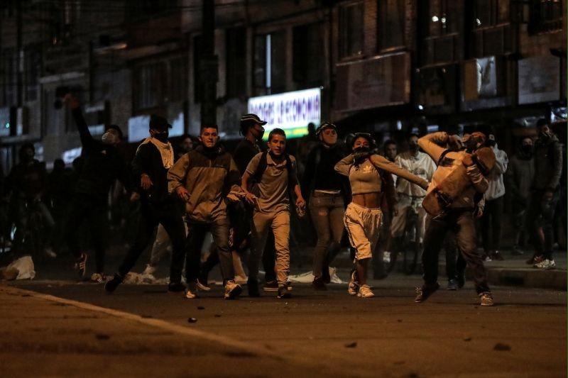 People protest outside a police station after a man, who was detained for violating social distancing rules, died from being repeatedly shocked with a stun gun by officers, according to authorities, in Bogota, Colombia on September 10. (REUTERS Photo)