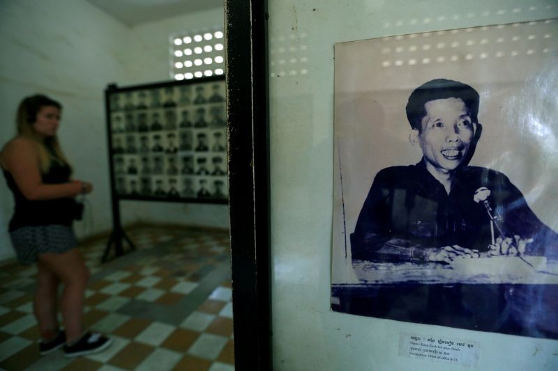 A visitor walks past a picture of Kaing Guek Eav, alias "Duch", a prison commander for the Khmer Rouge regime who died on Sept. 2, at the Tuol Sleng Genocide Museum in Phnom Penh, Cambodia on June 1, 2016. (REUTERS File Photo)
