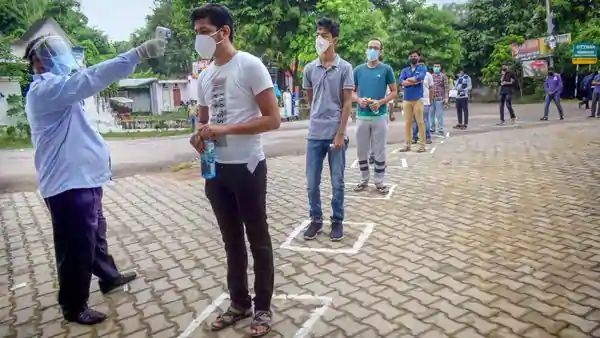 A student undergoes thermal screening as he waits to enter an examination centre. (PTI)