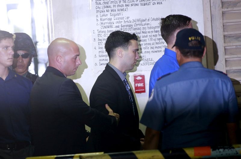 U.S. Marine Lance Corporal Joseph Scott Pemberton (C) is escorted by U.S. security officers into a court in Olongapo city, north of Manila on December 1, 2015. Pemberton, who is being held at a U.S. facility at the main army base in Manila, has been on trial for the murder of Jennifer Laude, who was found dead last year in a hotel in Olongapo City, near a former U.S. naval base northwest of the Philippine capital. (REUTERS File Photo)
