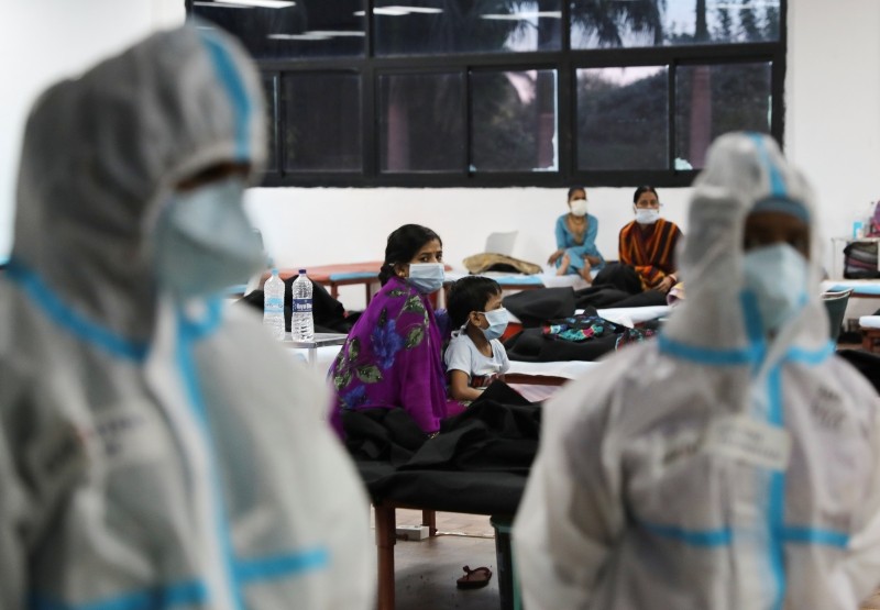 FILE PHOTO: A woman sits with her child inside a quarantine centre for the coronavirus disease (COVID-19) patients amidst the spread of the disease at an indoor sports complex in New Delhi, India, September 22, 2020. REUTERS/Anushree Fadnavis/File photo