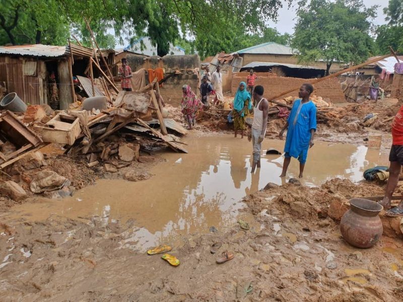 People stand outside after their houses were destroyed following heavy rains in Kebbi state, Nigeria in this handout picture taken September, 2020. (REUTERS Photo)