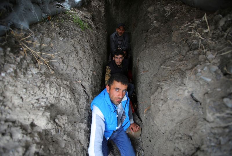 Local residents take shelter in a dugout during the fighting over the breakaway region of Nagorno-Karabakh in the city of Terter, Azerbaijan on September 30, 2020. (REUTERS Photo)