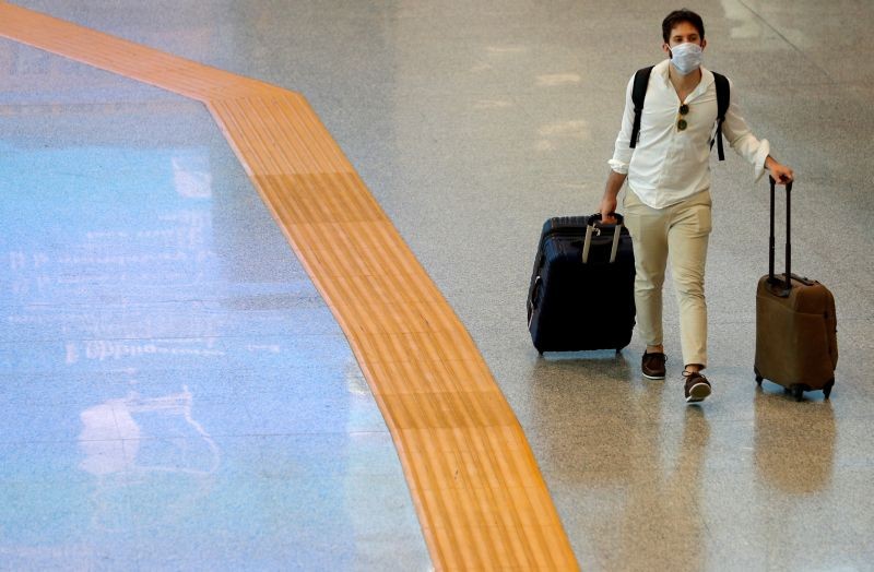 A passenger wearing a protective face mask walks at Fiumicino Airport In Rome, Italy on May 28, 2020. (REUTERS File Photo)